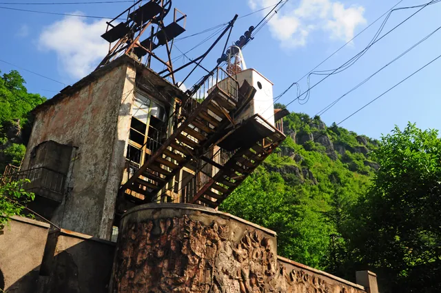 Old Soviet cable car station in Chiatura — rusty metal structures, external staircases and bas-relief decorations