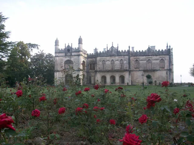 Dadiani Palace in Zugdidi seen through blooming roses in the botanical garden