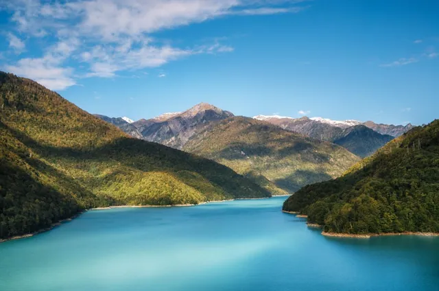 Jvari Reservoir in autumn — turquoise water and snow-capped Caucasus peaks