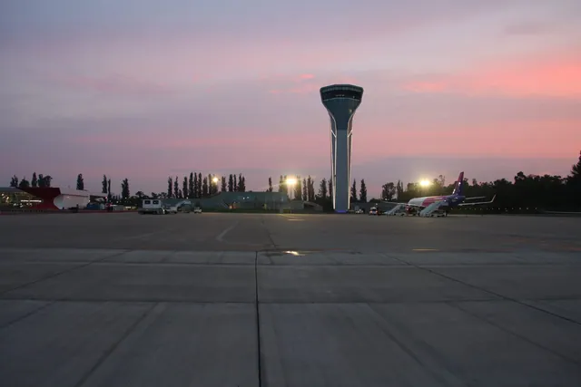 The apron at Kutaisi airport at sunset: the control tower and a Wizz Air aircraft