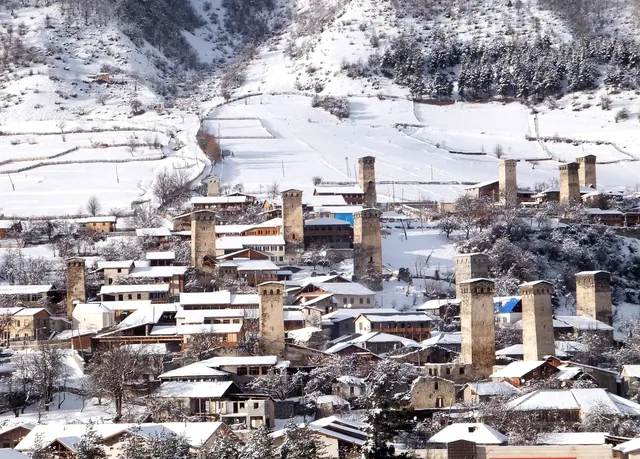 Mestia in winter: Svan towers and houses on a snow-covered slope