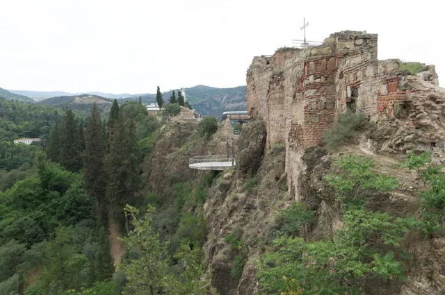 Narikala walls and Kartlis Deda on the ridge