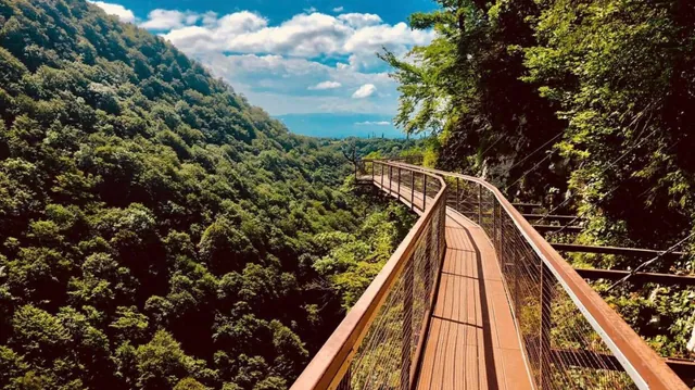 Okatse Canyon suspended walkway in summer — metal trail over the forested gorge, Imereti Georgia