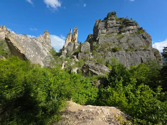 Sairme Pillars viewed from the hiking trail — limestone towers rising above lush Lechkhumi forests, Georgia