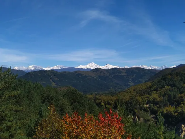 View of the Caucasus mountain range from Racha — snow-capped peaks and autumn forest, Georgia