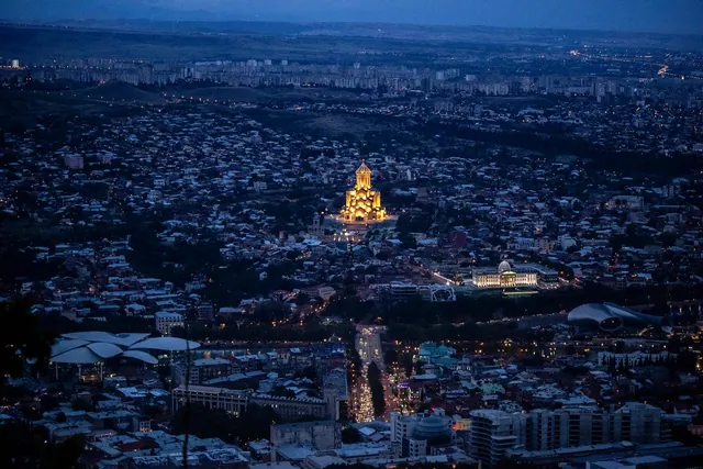 The Holy Trinity Cathedral (Tsminda Sameba) on St. Elias Hill lit up in the evening