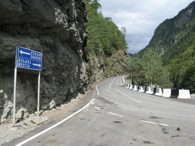 A Chuberi / Mestia road sign on switchbacks above the gorge