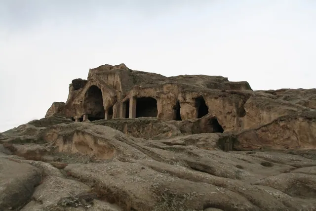 Halls and columns cut into the rock at Uplistsikhe