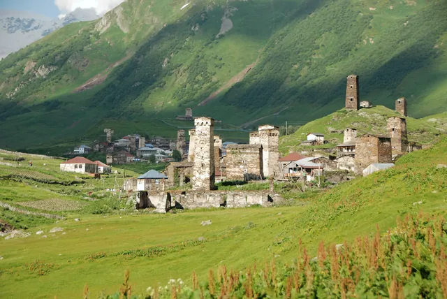 Svan towers of Ushguli village against green mountains, Svaneti, Georgia